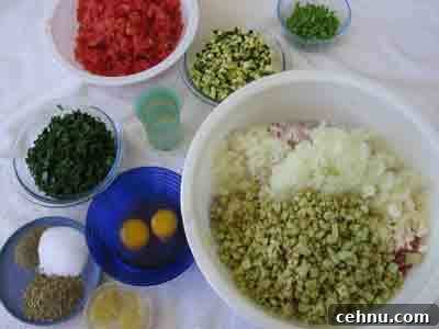 Adding more ingredients for greek recipe keftedes kalokairinoi summer meatballs.