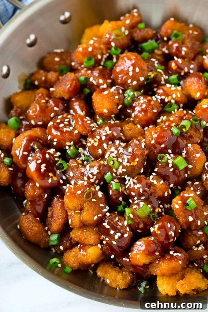 A pan of popcorn shrimp in an Asian sesame sauce.