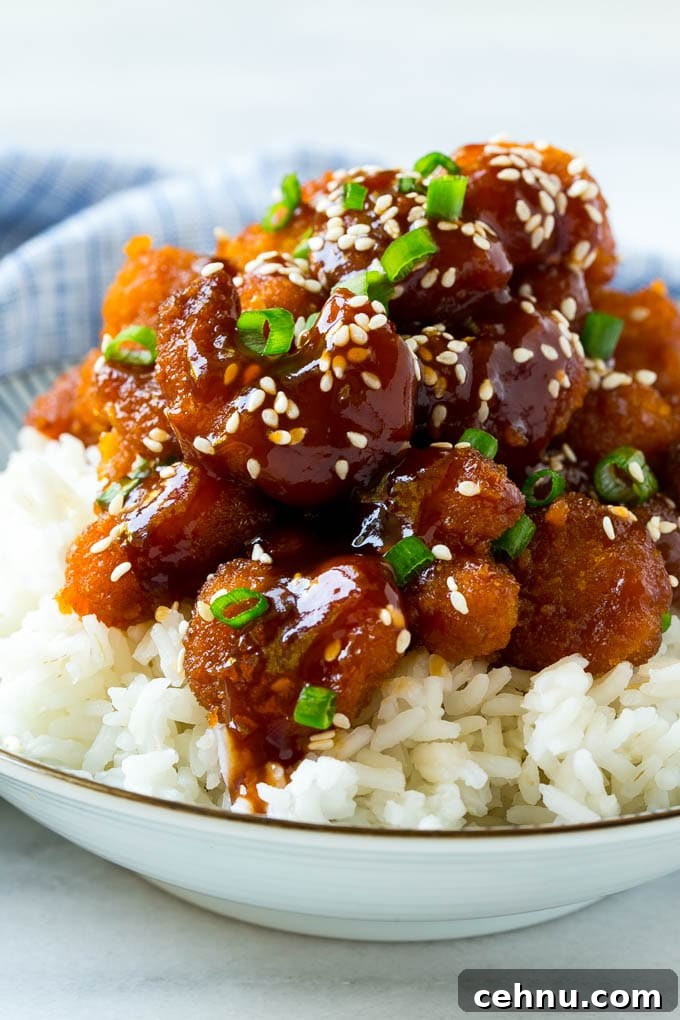 A bowl of Asian style crispy sesame shrimp over rice.