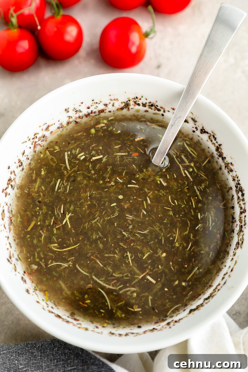 A small white bowl filled homemade red wine vinaigrette for pasta salad