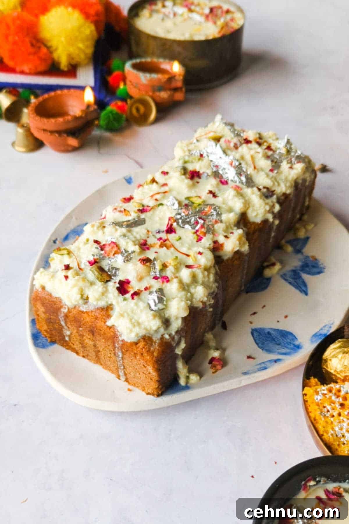 gulab jamun mix loaf cake adorned with instant rabdi placed on a white and blue plate