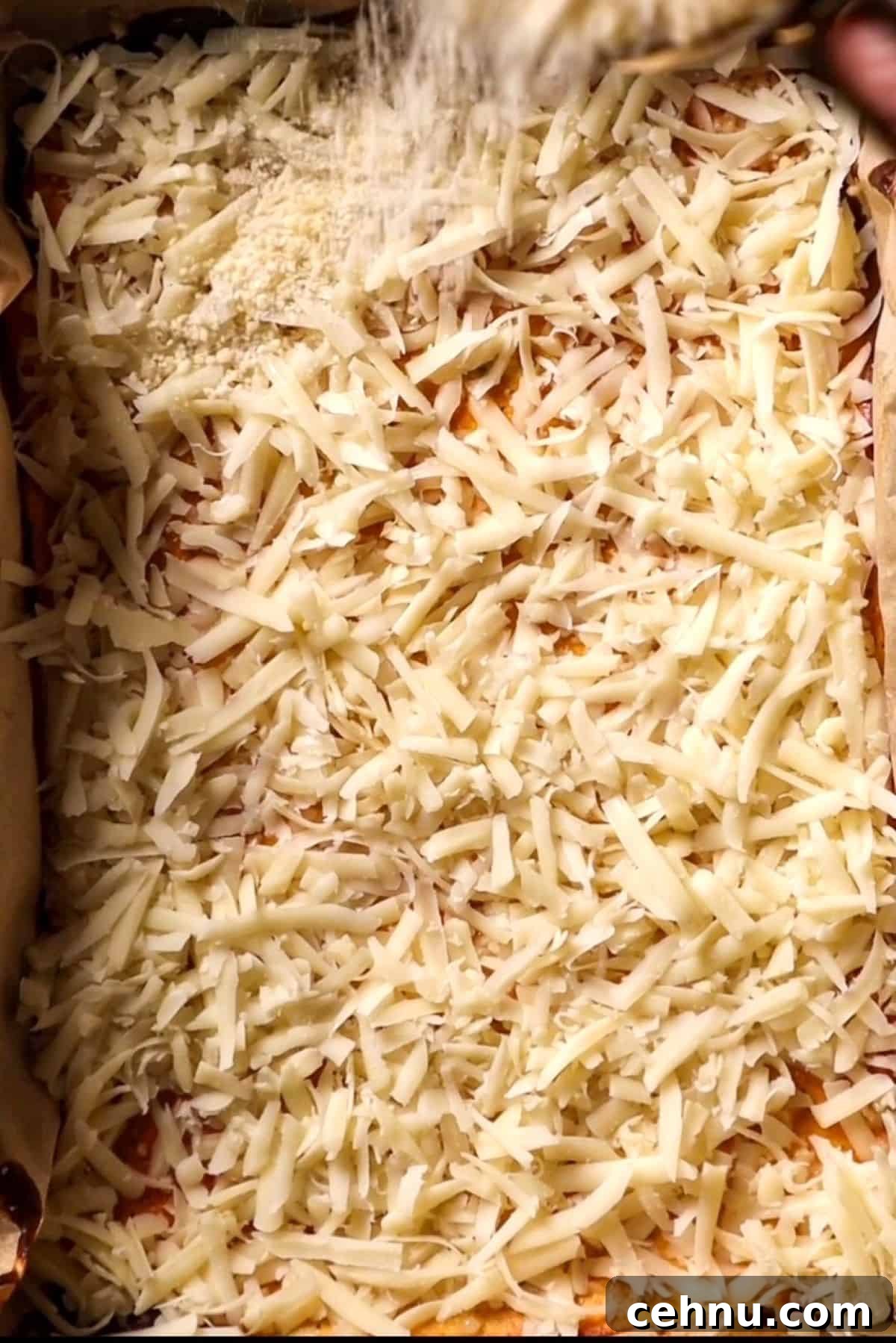 shredded mozzarella cheese on a cottage cheese crust
