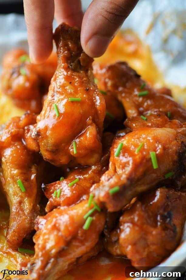 Crispy Spicy Garlic Wings Recipe 3 Copycat Buffalo wild wings spicy garlic chicken wings being lifted