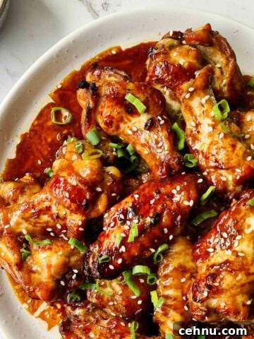 Close up of sticky soy wings on a white plate
