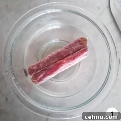 Two Chinese sausages soaking in warm water