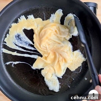 Eggs scrambling in a hot pan