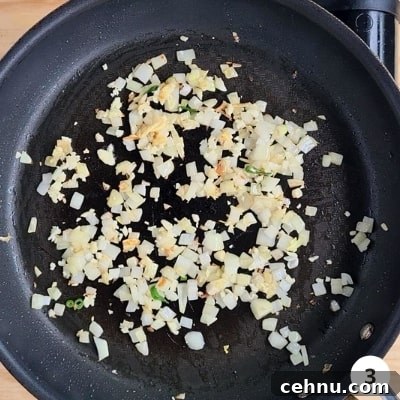 finely diced onions and minced garlic sauteeing in a hot non-stick pan