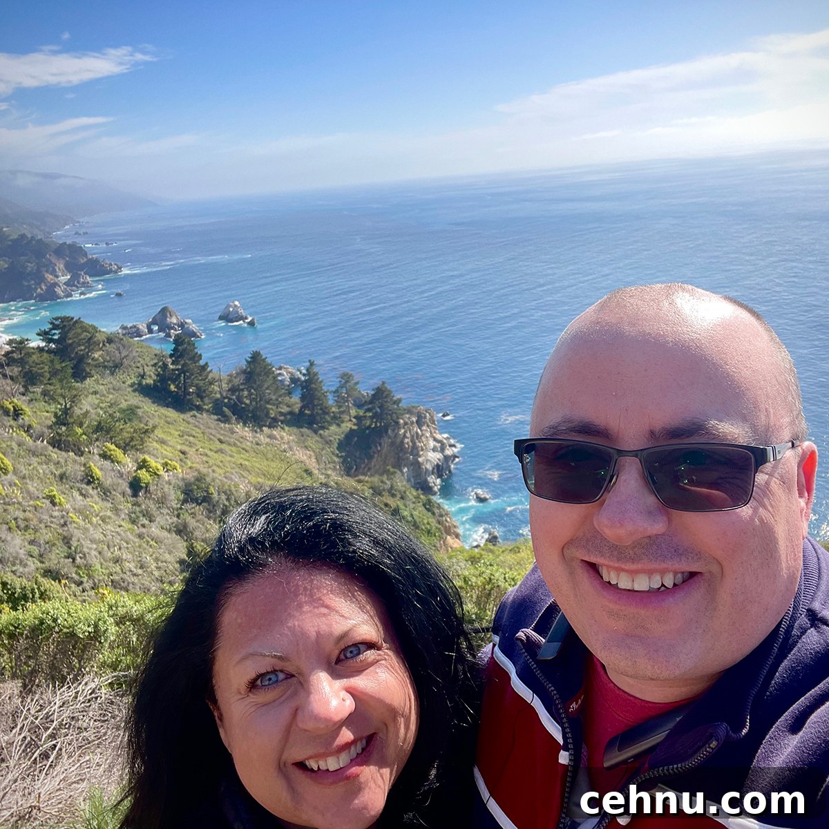 Lets Get Lost February 2022 Travel Inspiration 16 Steve and Rebecca Blackwell standing at the top of a cliffside overlooking the Pacific Ocean along the California coast.