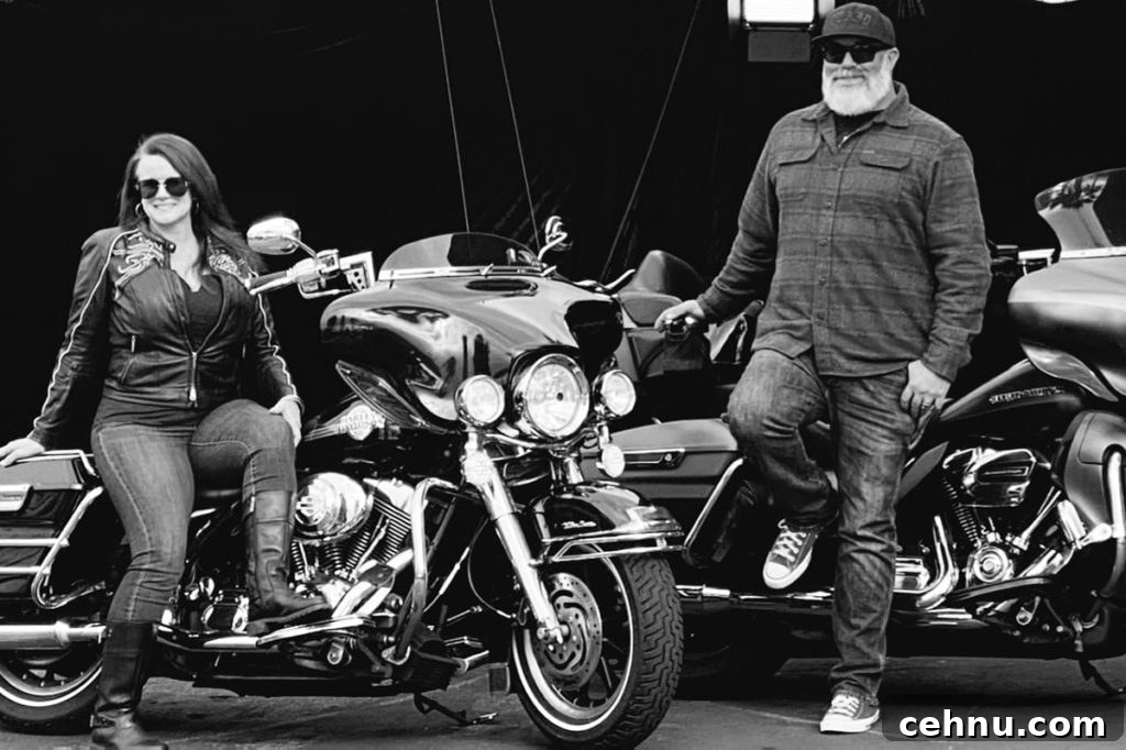 Lets Get Lost February 2022 Travel Inspiration 18 A black and white photo of Dustin and Brenda Taylor standing next to their motorcycles.