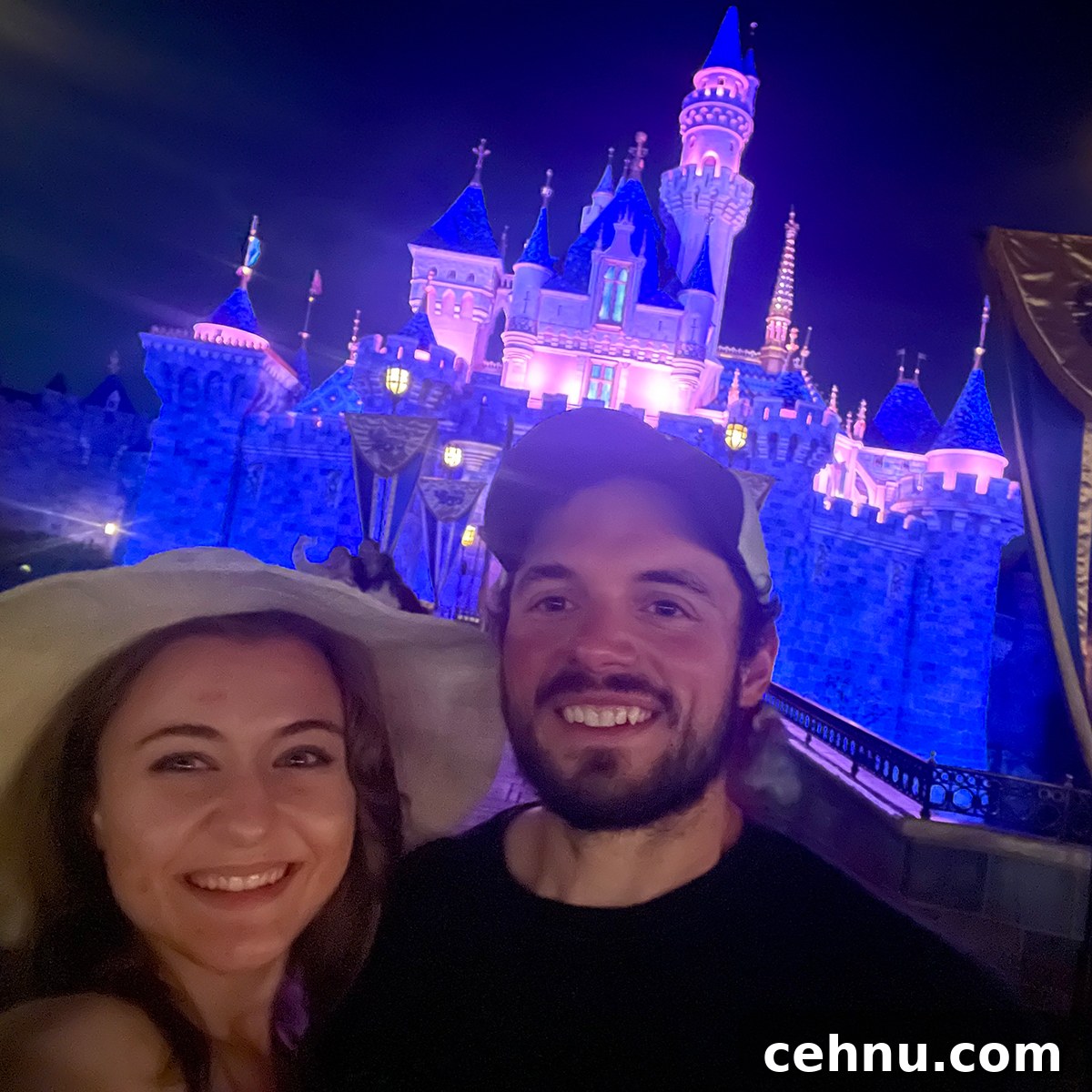 Lets Get Lost February 2022 Travel Inspiration 26 Annie and Scott standing in front of the Cinderella castle at night.