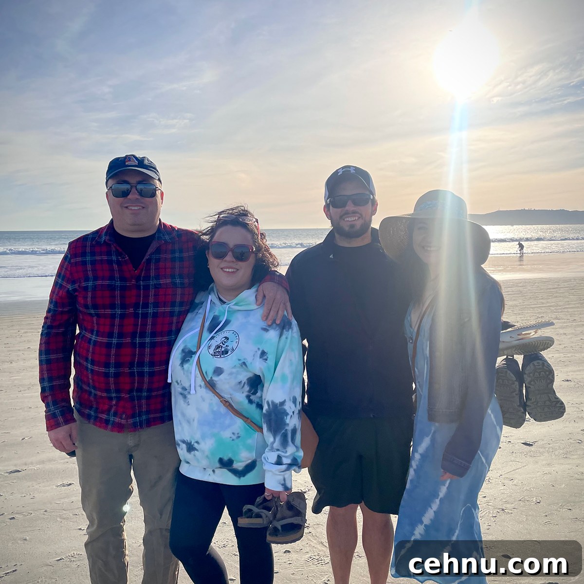 Lets Get Lost February 2022 Travel Inspiration 9 Steve, Kate, Scott, and Anne standing with their arms around each other on a beach in Coronado, California.