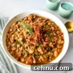 15+ Homemade Soup Recipes for Cozy Weeknight Meals 11 White bowl with 15 bean soup and a striped cloth.