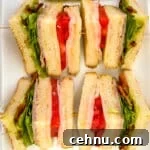 15+ Homemade Soup Recipes for Cozy Weeknight Meals 27 Four slices of chicken club sandwich on a white plate.