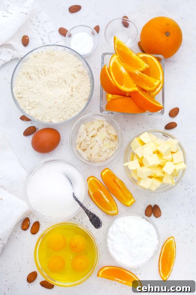 overhead shot of ingredients for almond orange cake arranged in bowls on a table