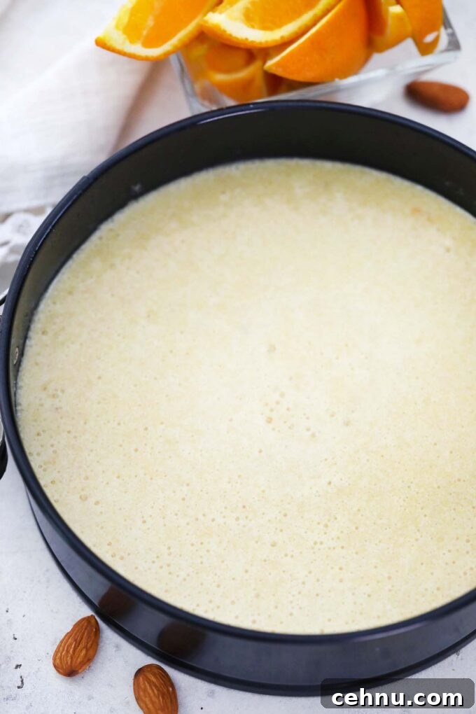 almond orange cake raw batter in a springform pan