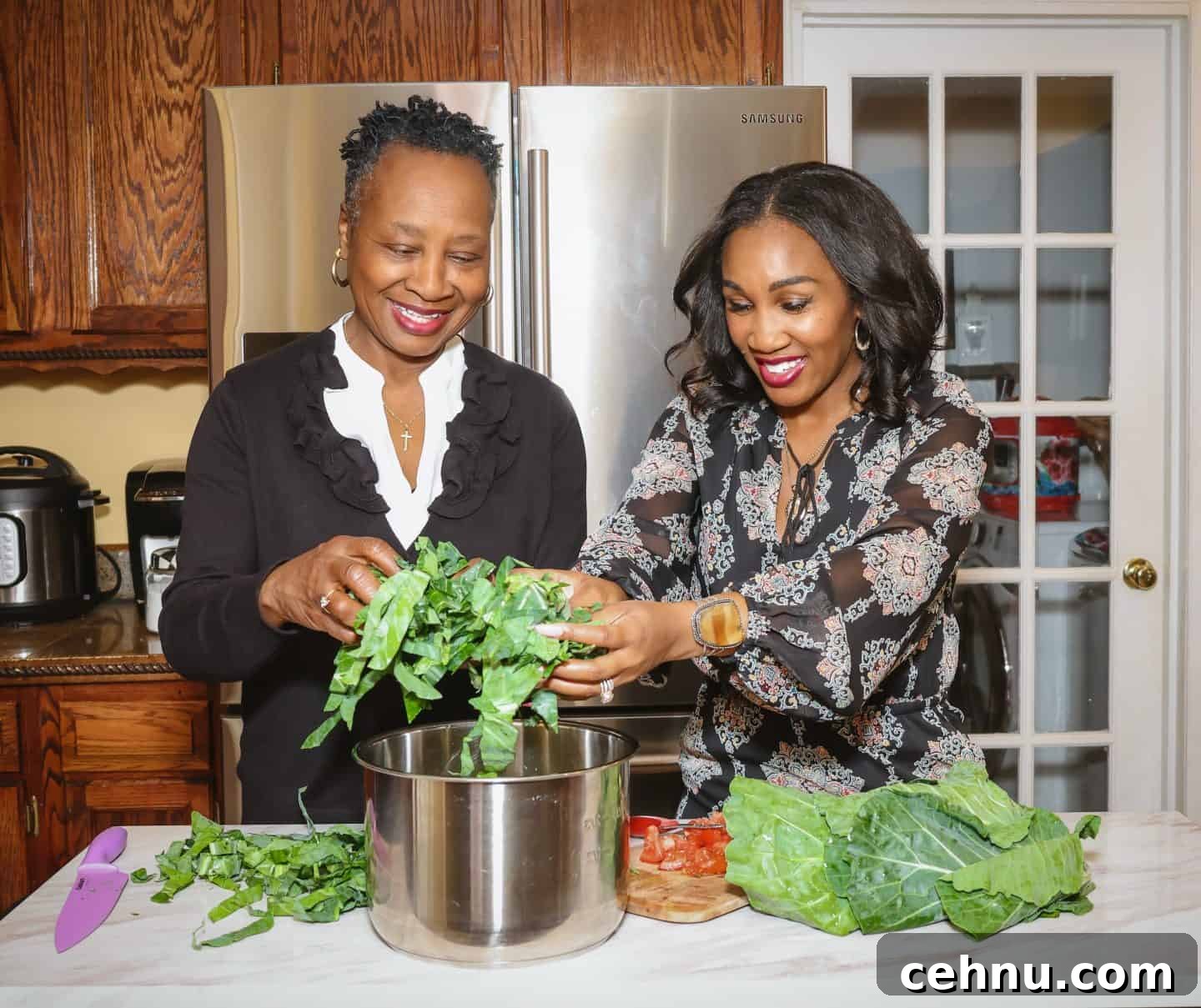 How to make collard greens by Shaunda Necole & The Soul Food Pot® - Shaunda Necole and her mom are preparing freshly chopped collard greens in a large pot, demonstrating how Black folks’ soul food collard greens are built layer by layer with care, tradition, and time-honored cooking methods.