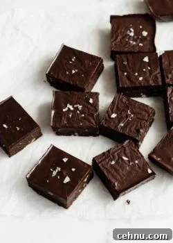 raw chocolate brownies cut up in squares on parchment paper