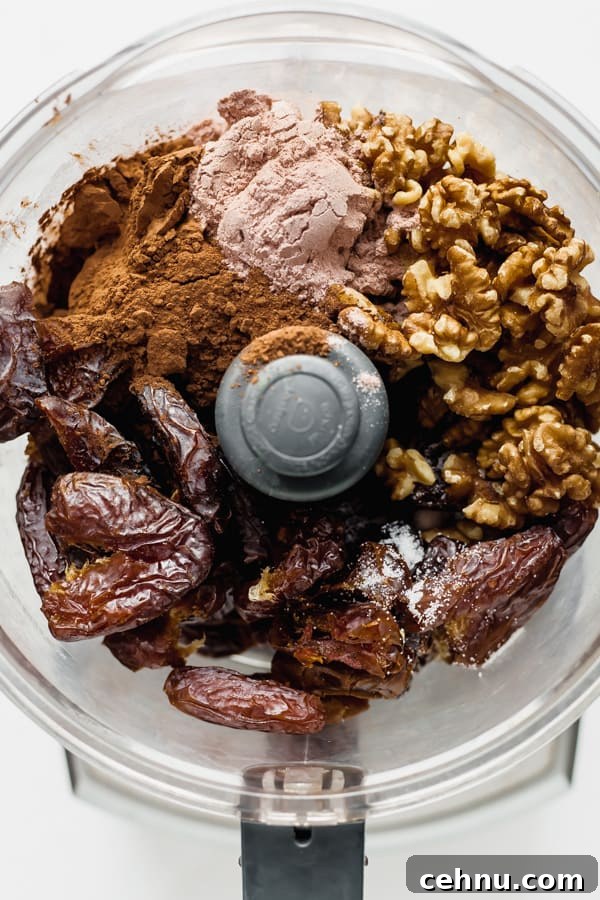 a food processor with ingredients for no bake brownies in it