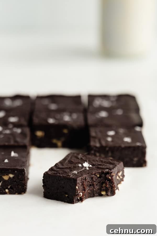 a no bake brownie with a bite taken out of it topped with sea salt