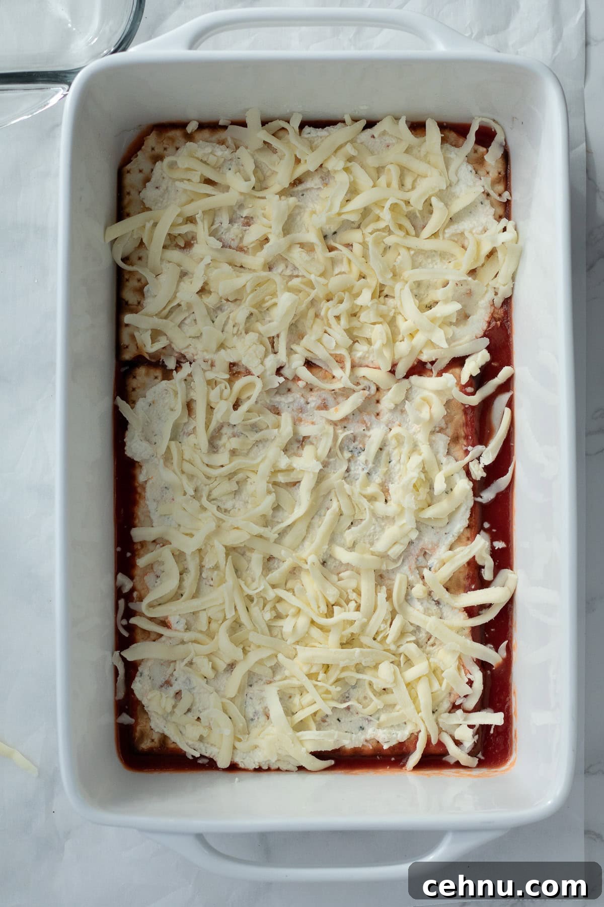 5-Ingredient Matzo Lasagna for Passover Dinner 7 shredded cheese layer in a matzo lasagna