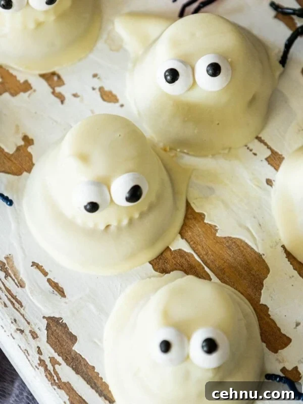 Halloween Mummy Meatloaf Recipe 15 Cookies dipped in white chocolate with candy eyes to look like ghosts.