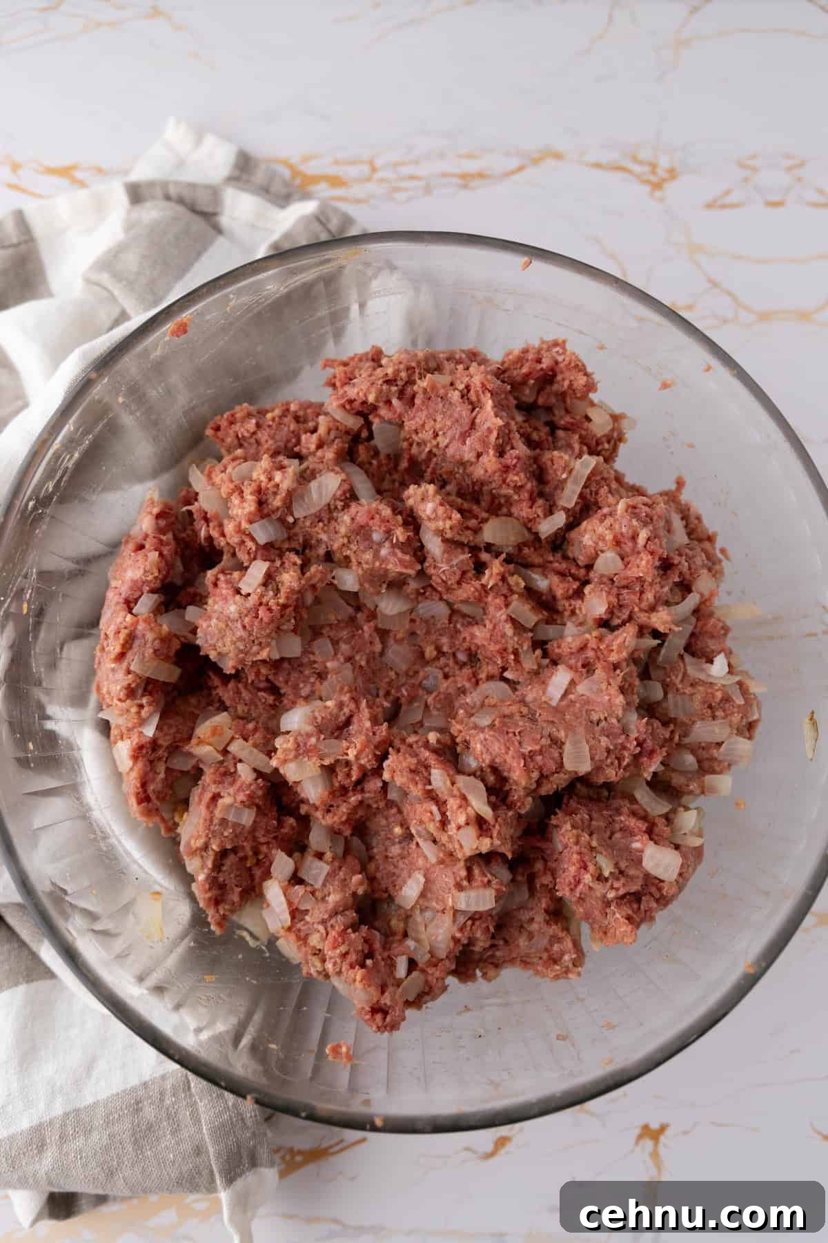 Halloween Mummy Meatloaf Recipe 9 Ground meat mixture for mummy meatloaf in a glass bowl.