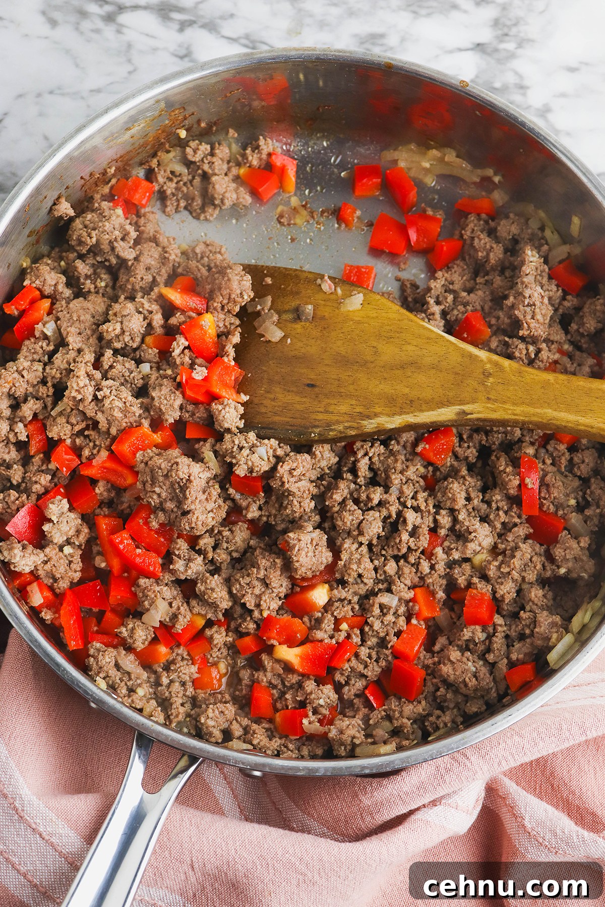 Cheesy Tater Tot Casserole with Ground Beef Recipe 5 Browning ground beef, red pepper and onion in saucepan.