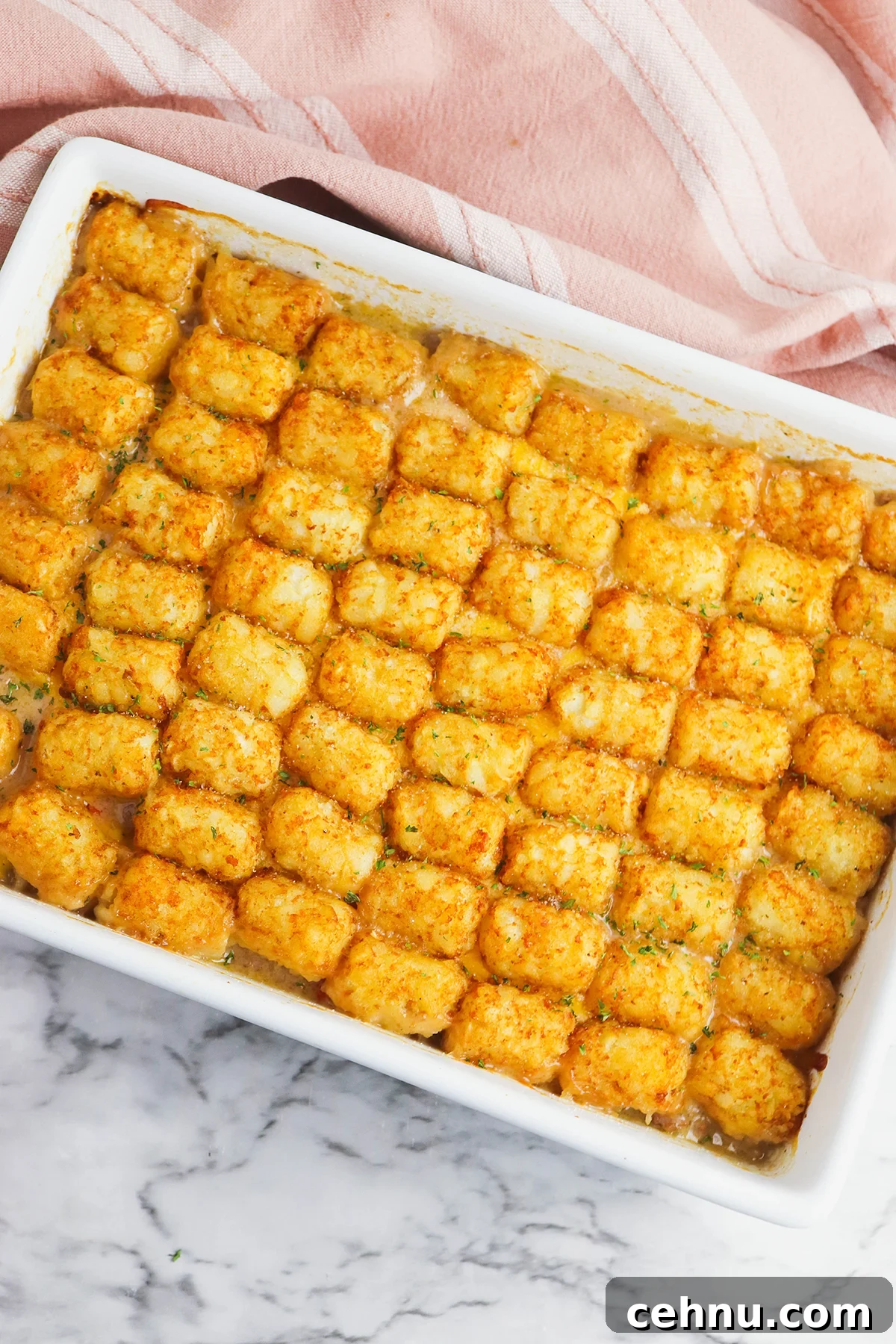 Cheesy Tater Tot Casserole with Ground Beef Recipe 10 Baked Tater Tot Casserole cooling in baking dish on counter.