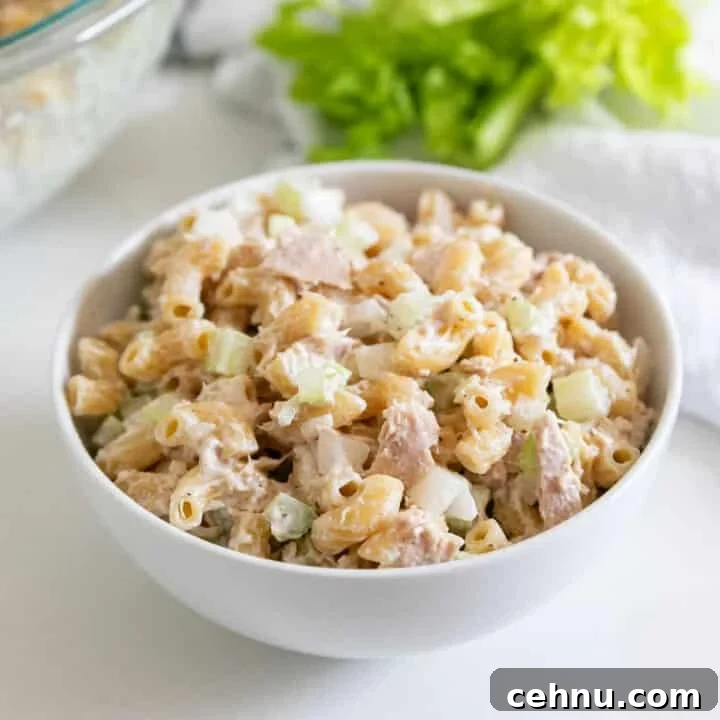 A white bowl full of classic tuna macaroni salad.