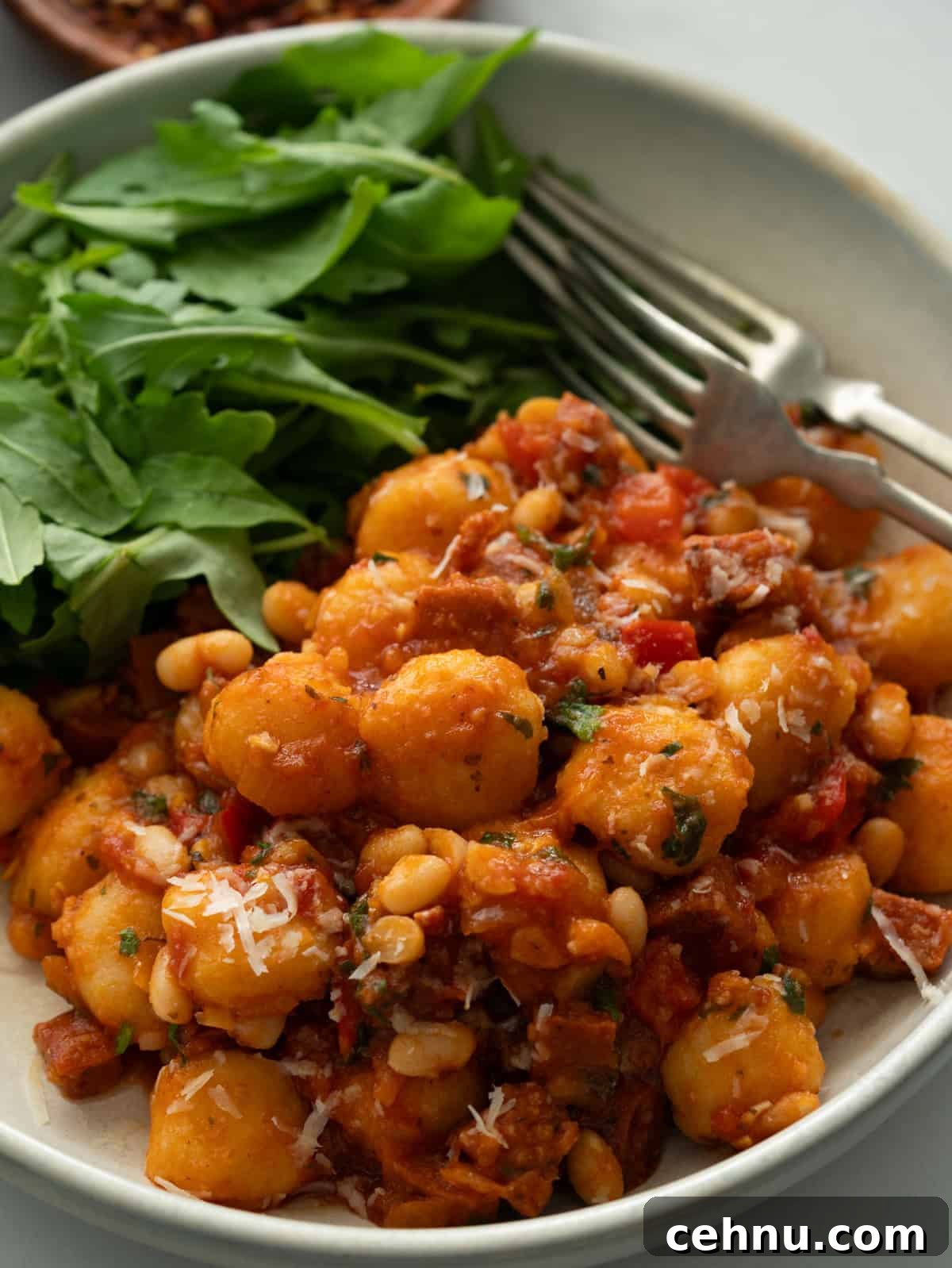 One-Pot Chorizo Gnocchi Recipe 14 Close up of chorizo gnocchi with white bean.