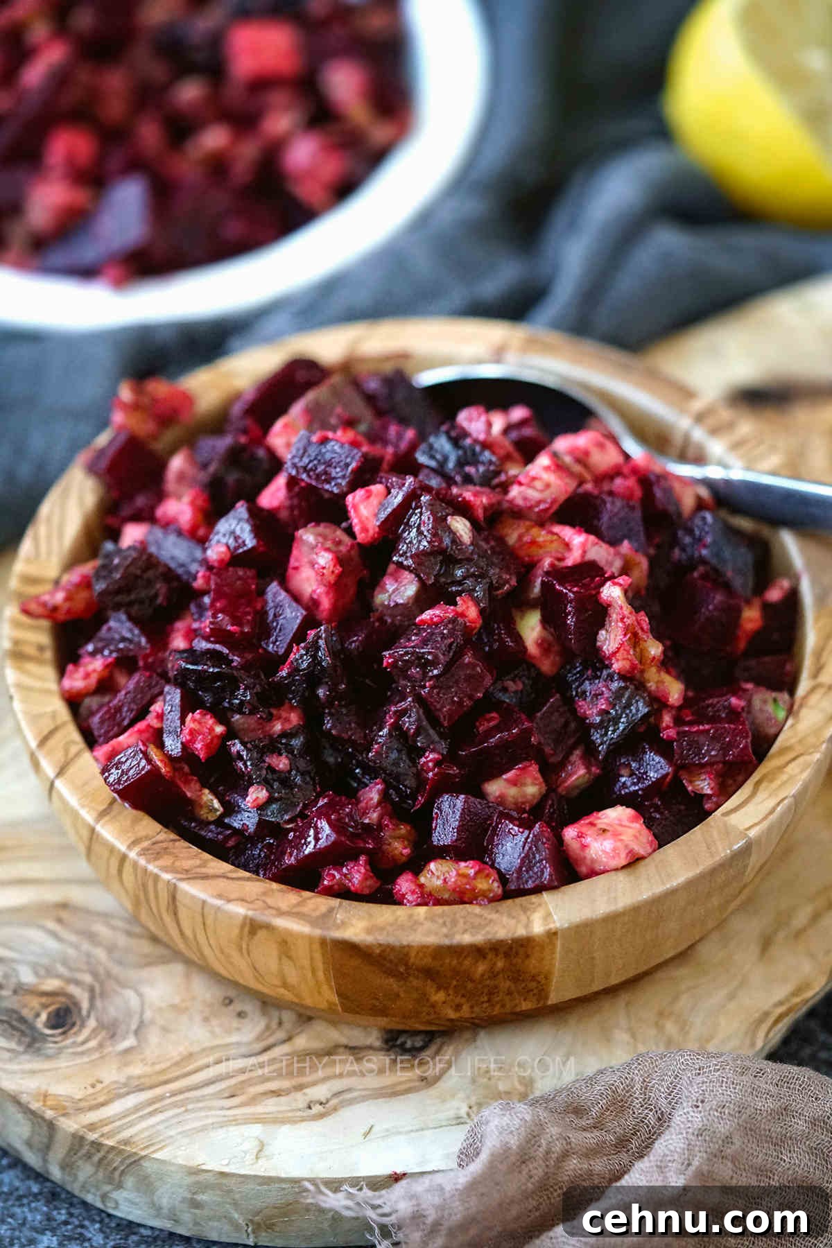 Russian salad with beets walnuts prunes and avocado - cold beet salad with vegan ingredients in a bowl.