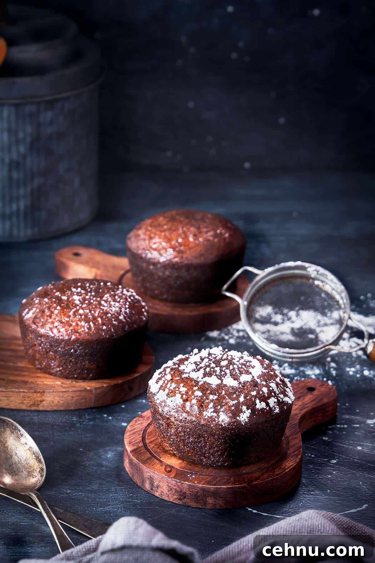 Authentic South African Malva Pudding Cake Recipe 8 Malva pudding cakes lined up, dusted with powdered sugar