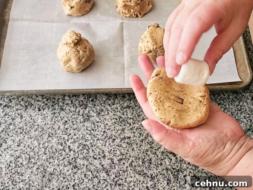 Chewy Gluten Free Smores Cookies Recipe 9 adding large marshmallow to flattened ball of dough.
