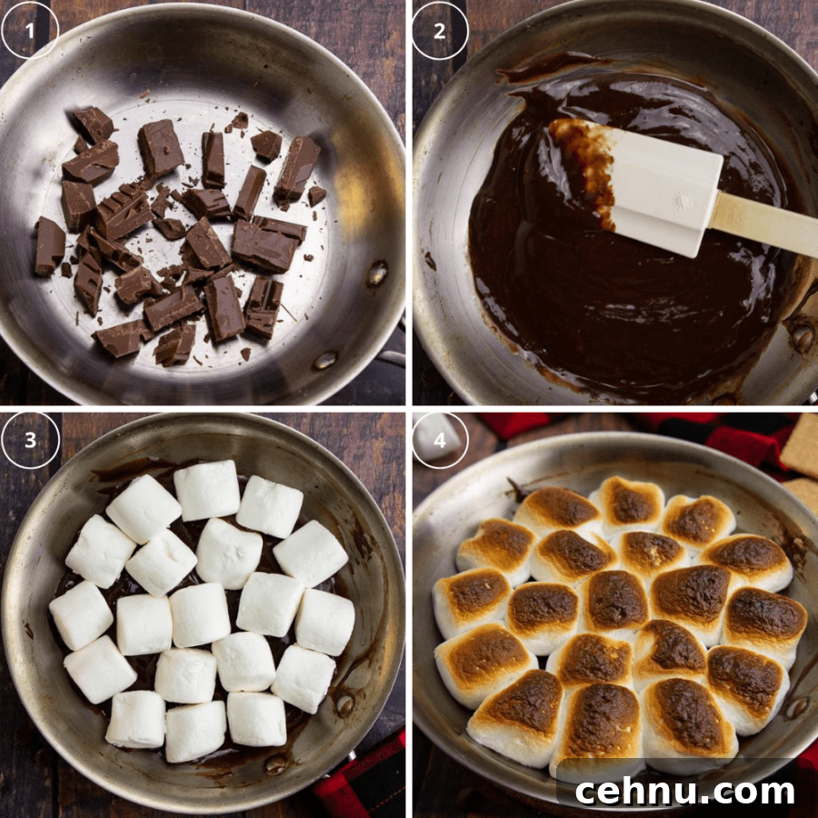 Oven S'mores Dip with Toasted Marshmallows 5 a steel pan with chocolate chunks being melted then topped with marshmallows that get toasted.