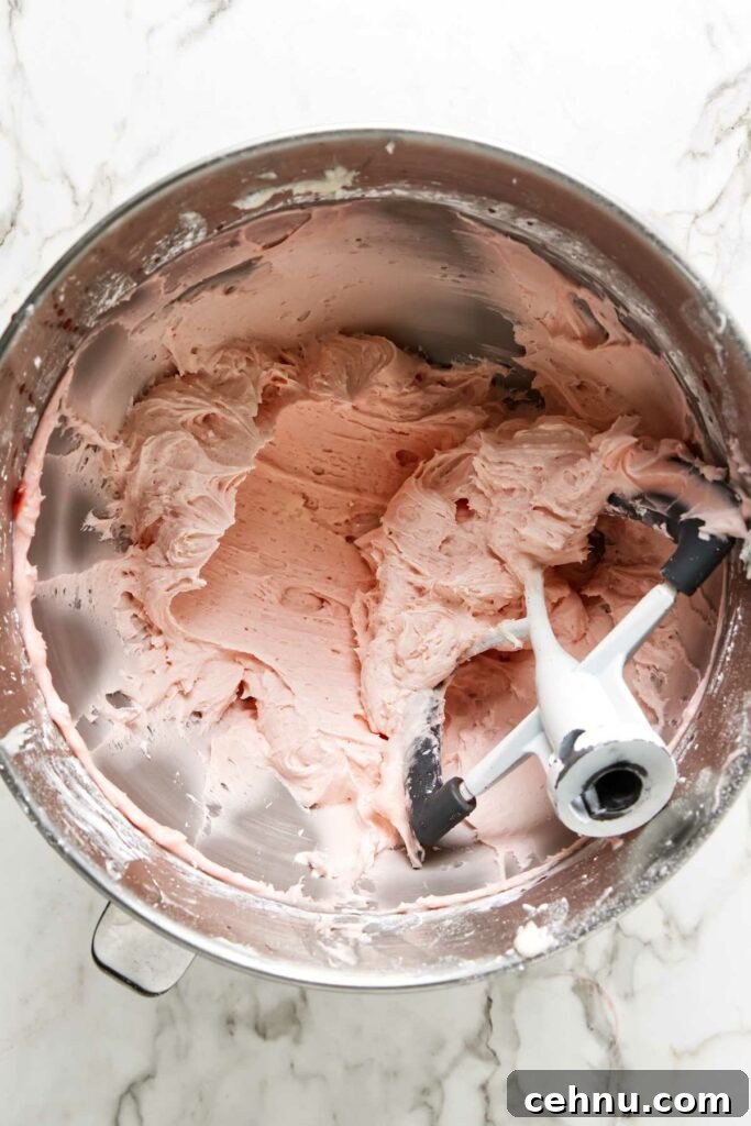 Maraschino cherry buttercream frosting in a mixing bowl.