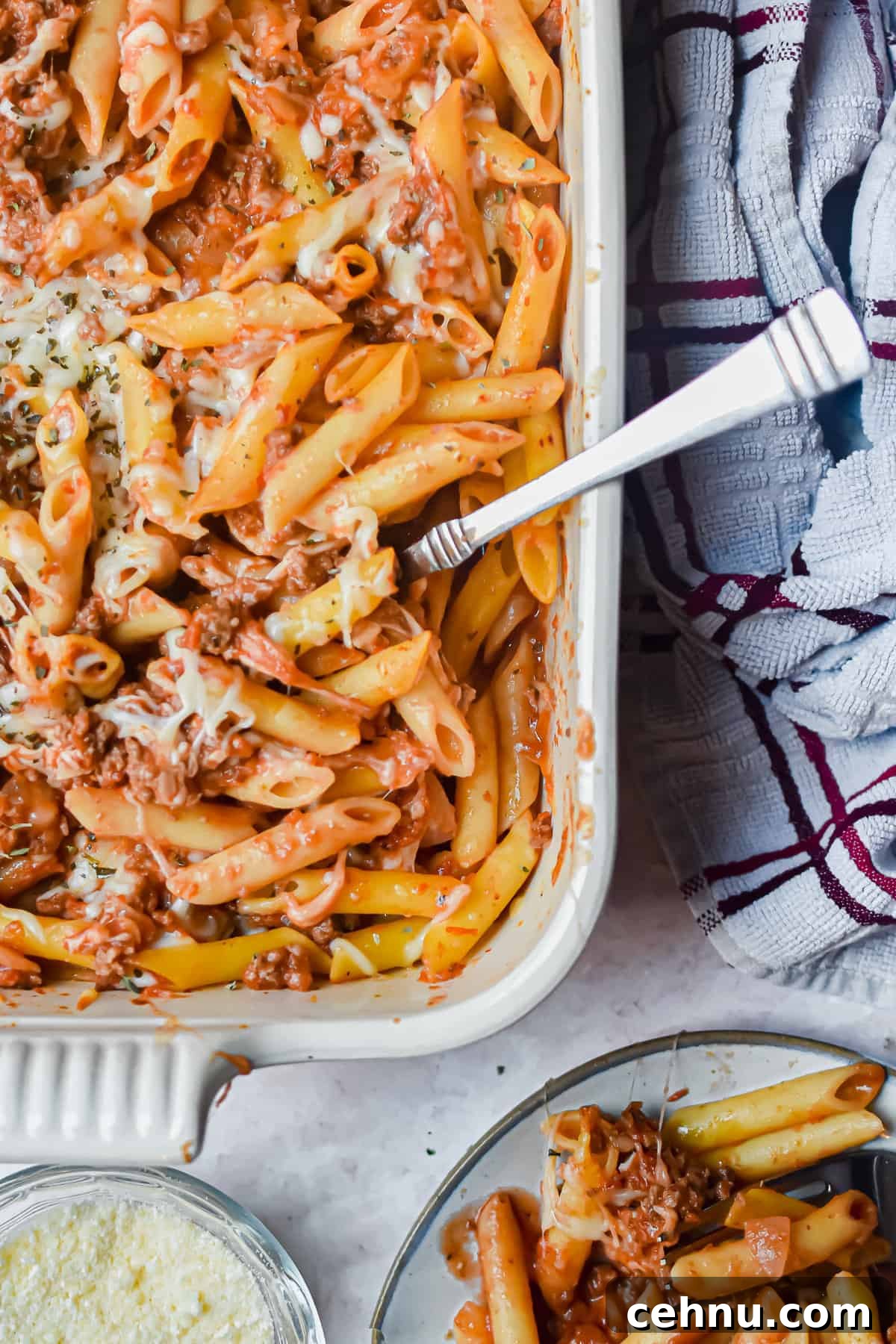 A close of up the meaty marinara in the baking dish and a portion is on a plate.