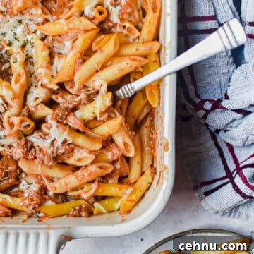 A close of up the meaty marinara in the baking dish and a portion is on a plate.