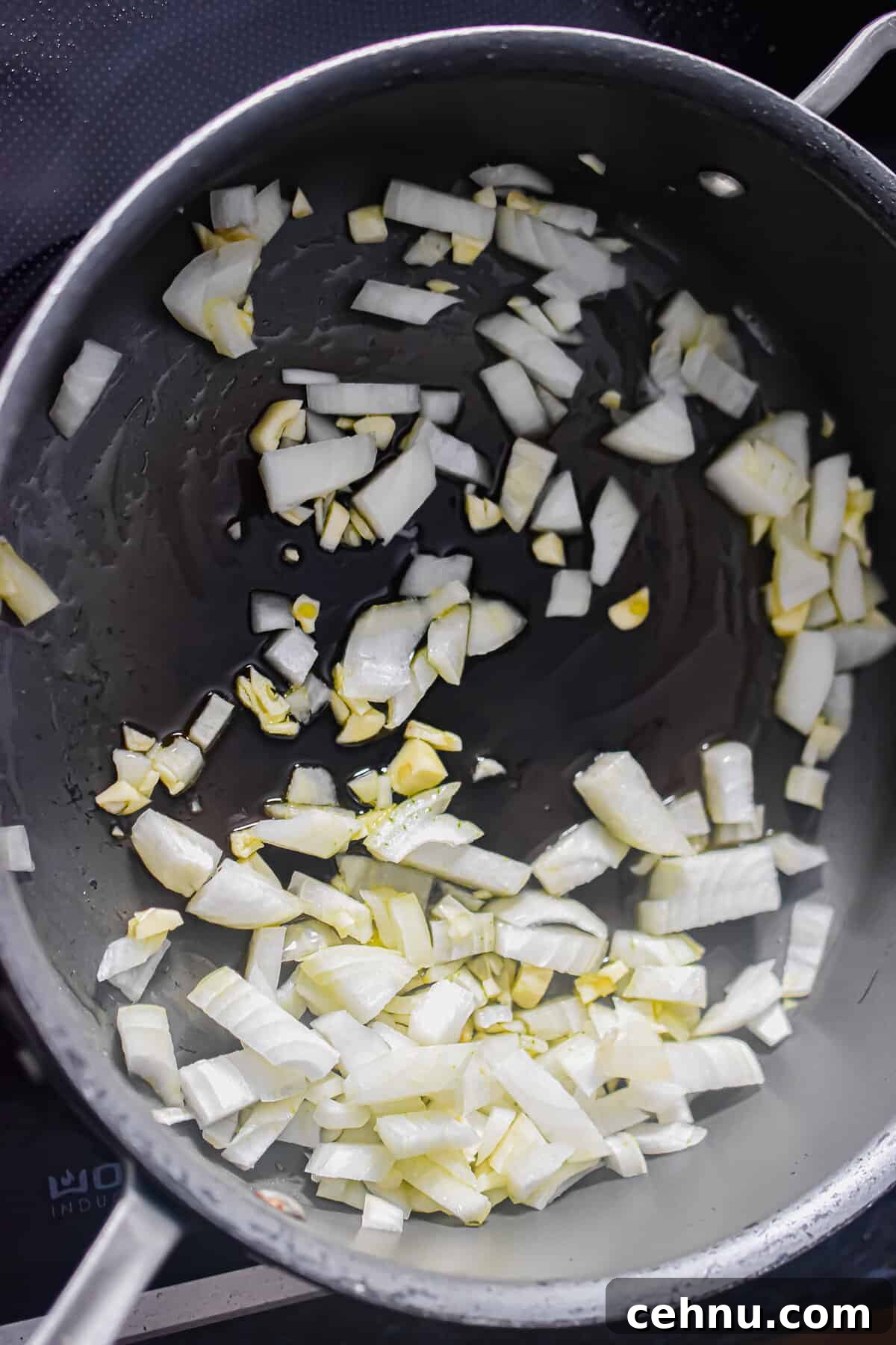 The onions and garlic are being sauteed in olive oil.