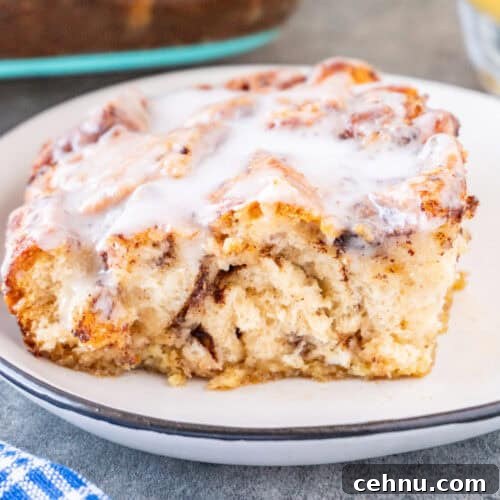 Slice of Cinnamon Roll French Toast on a white plate, featured image.