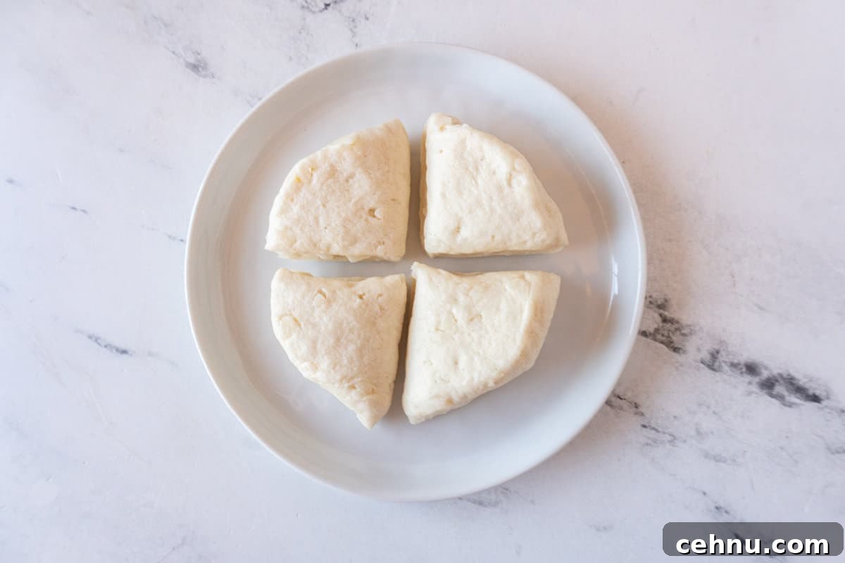 biscuit cut in 4 pieces on white plate.