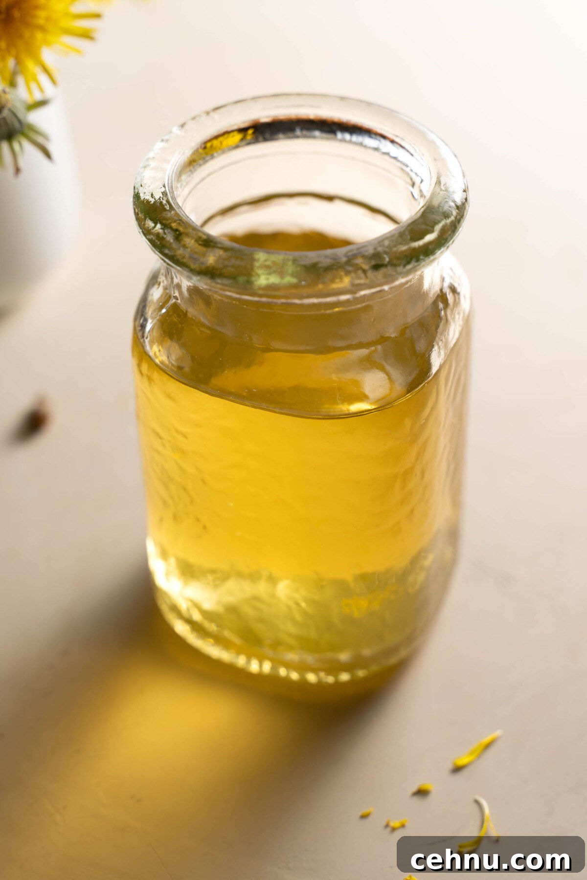 How to Make Dandelion Flower Cupcakes 3 A glass jar full of beautiful bright yellow dandelion syrup