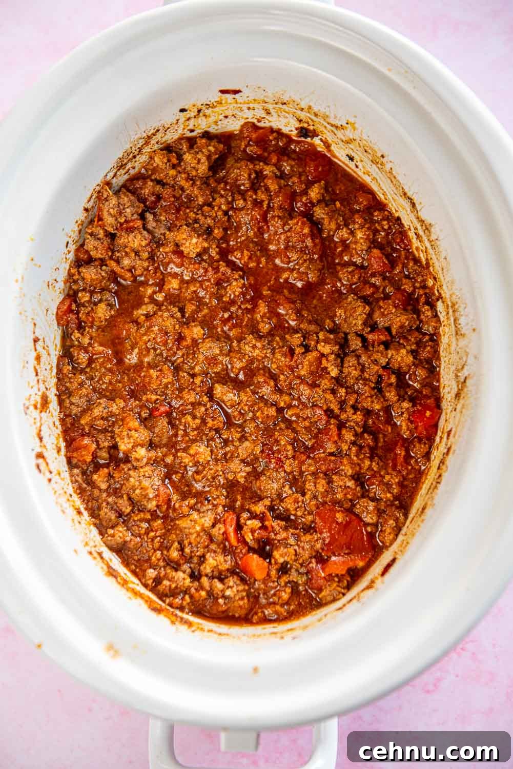 Slow Cooker Taco Meat Recipe: Tender, Flavorful Filling 6 Cooked taco meat in red sauce inside a white slow cooker bowl