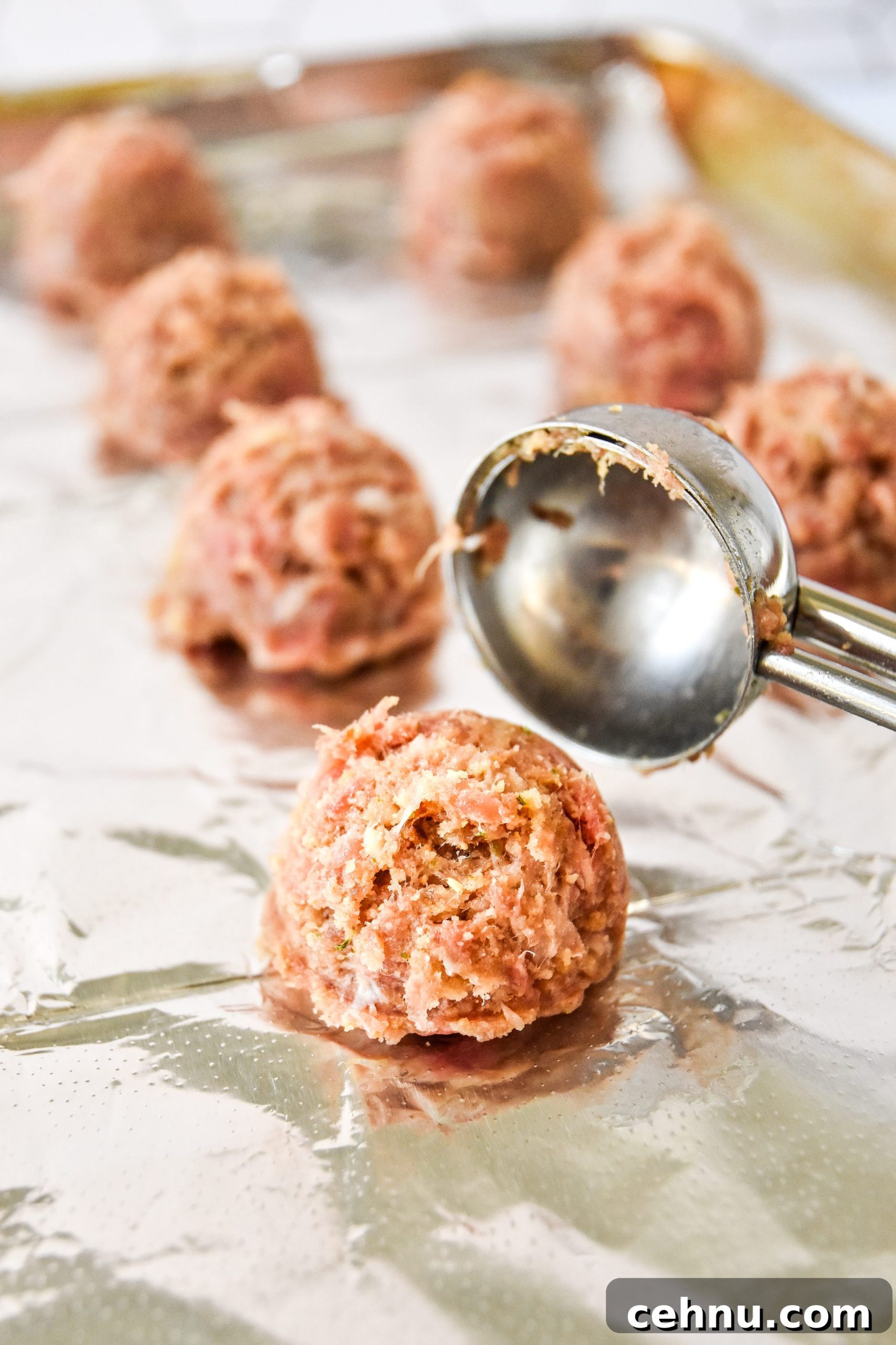 Make-Ahead Freezer Meatballs Recipe for Meal Prep 7 making meatballs using a cookie scoop.