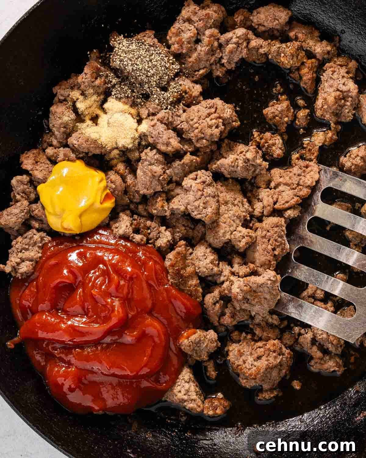 Garlic Bread Sloppy Joes Recipe for Cheesy Saucy Sandwiches 6 ground beef in pan with ketchup mustard and seasonings.