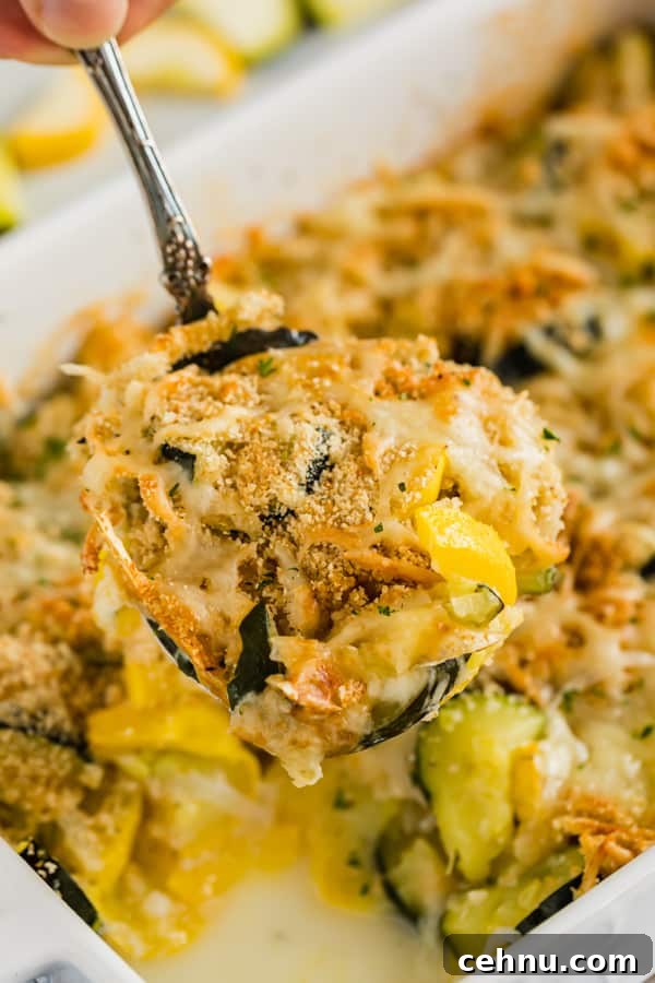 Cheesy Yellow Squash Casserole Recipe 5 A spoon with scoop of squash casserole