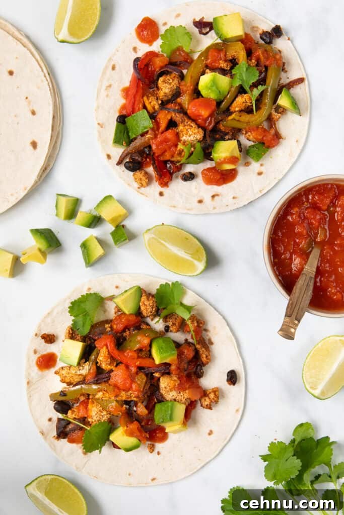These homemade tofu fajitas inside of gluten-free tortillas topped with salsa, cilantro, and avocados.