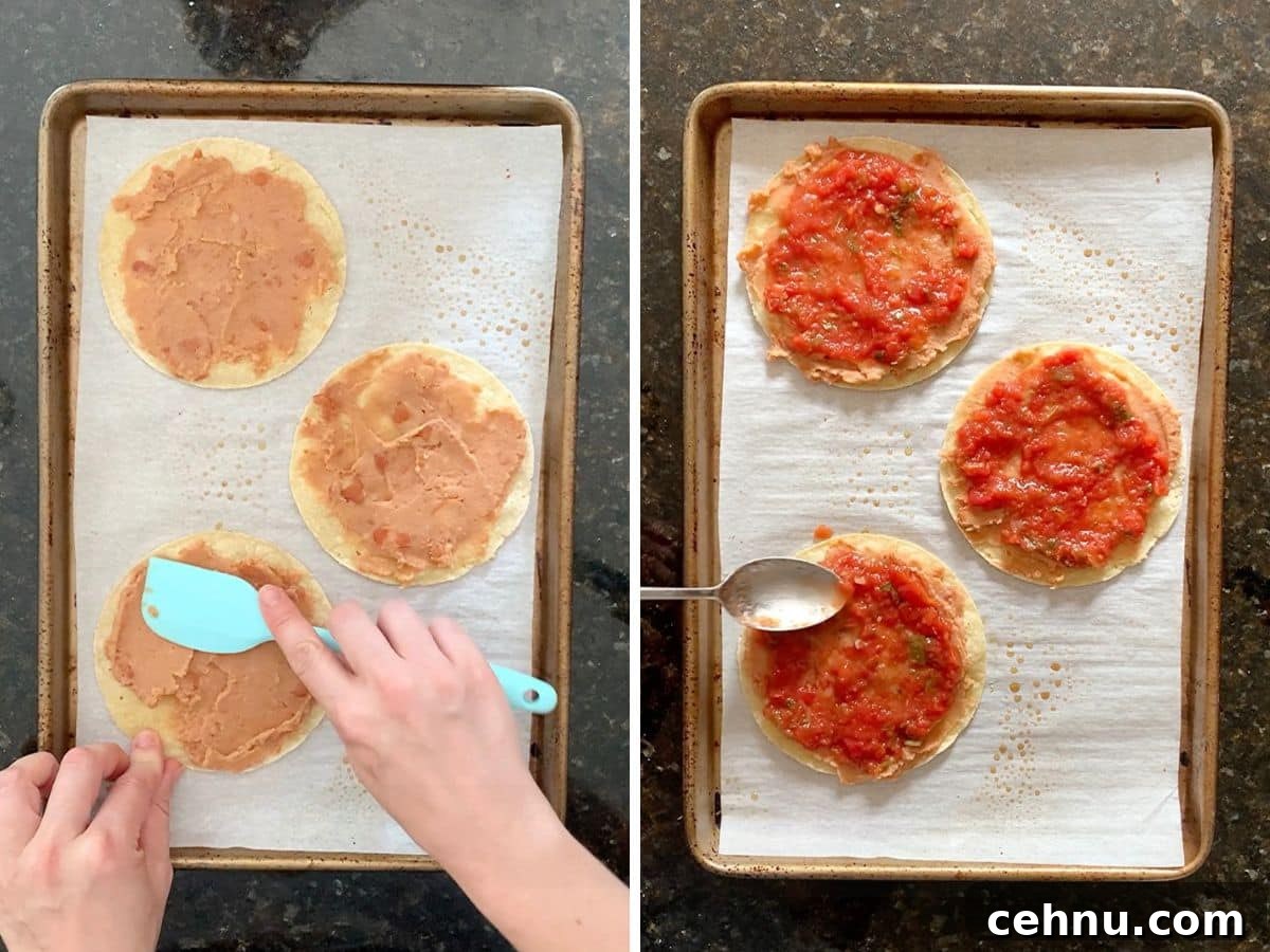 Hands spreading refried beans onto the baked corn tortillas and then salsa on top of that.