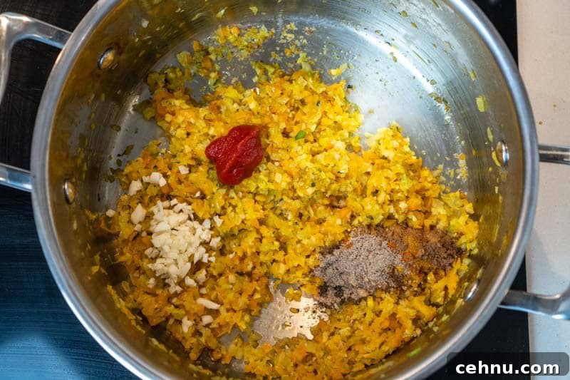 Adding the tomato paste, garlic and spices