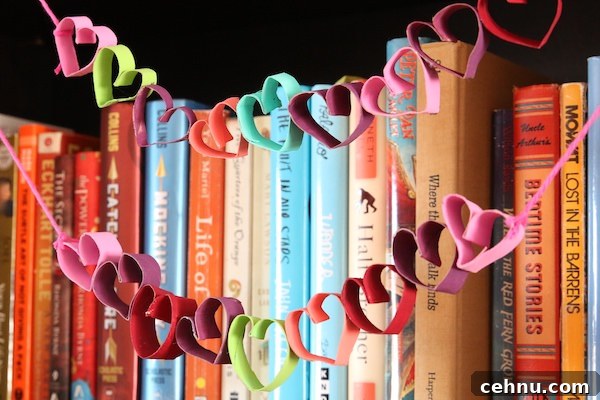 More Than 30 Toilet Paper Roll Crafts and Activities for Kids 12 colourful tp roll heart garland strung across shelf of books