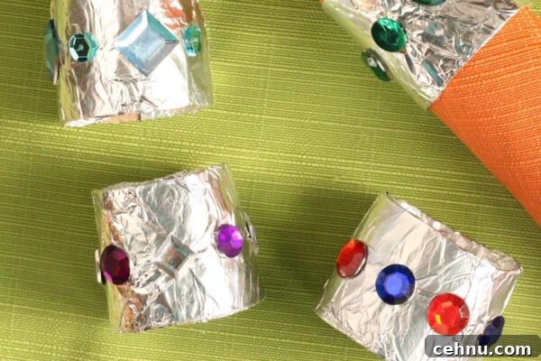 More Than 30 Toilet Paper Roll Crafts and Activities for Kids 8 paper towel roll covered in foil napkin rings with orange napkin